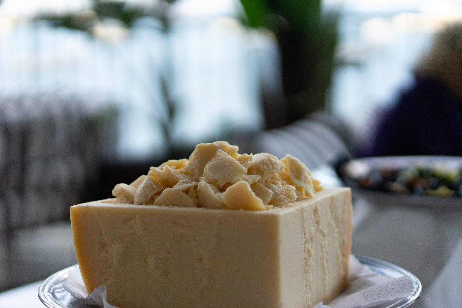 Sicilian wedding food detail — a block of aged local cheese piled high with hand-broken shards at a reception