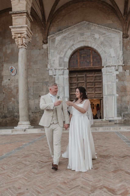Gráinne and Phil toasting outside the Norman cloister in Cefalù, Sicily