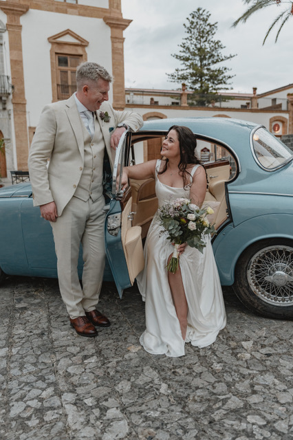 Gráinne in the powder-blue vintage car, Phil at the door