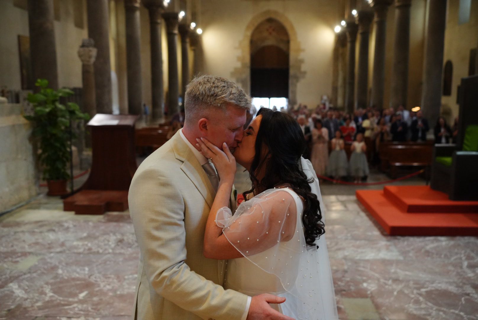 Gráinne and Phil sharing a kiss inside the Duomo di Cefalù