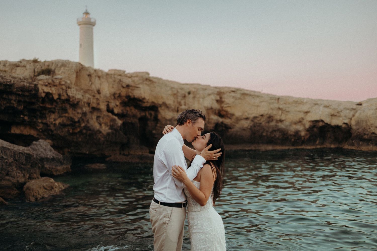 Dramatic cliffside couple at sunset