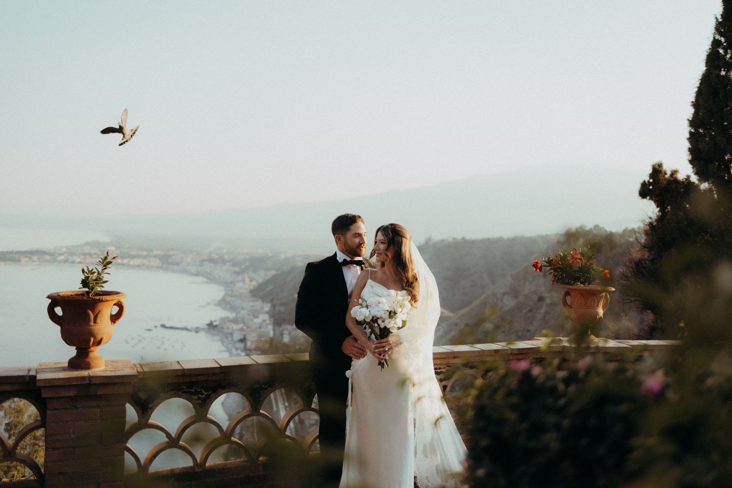 Couple on a Taormina terrace overlooking the sea