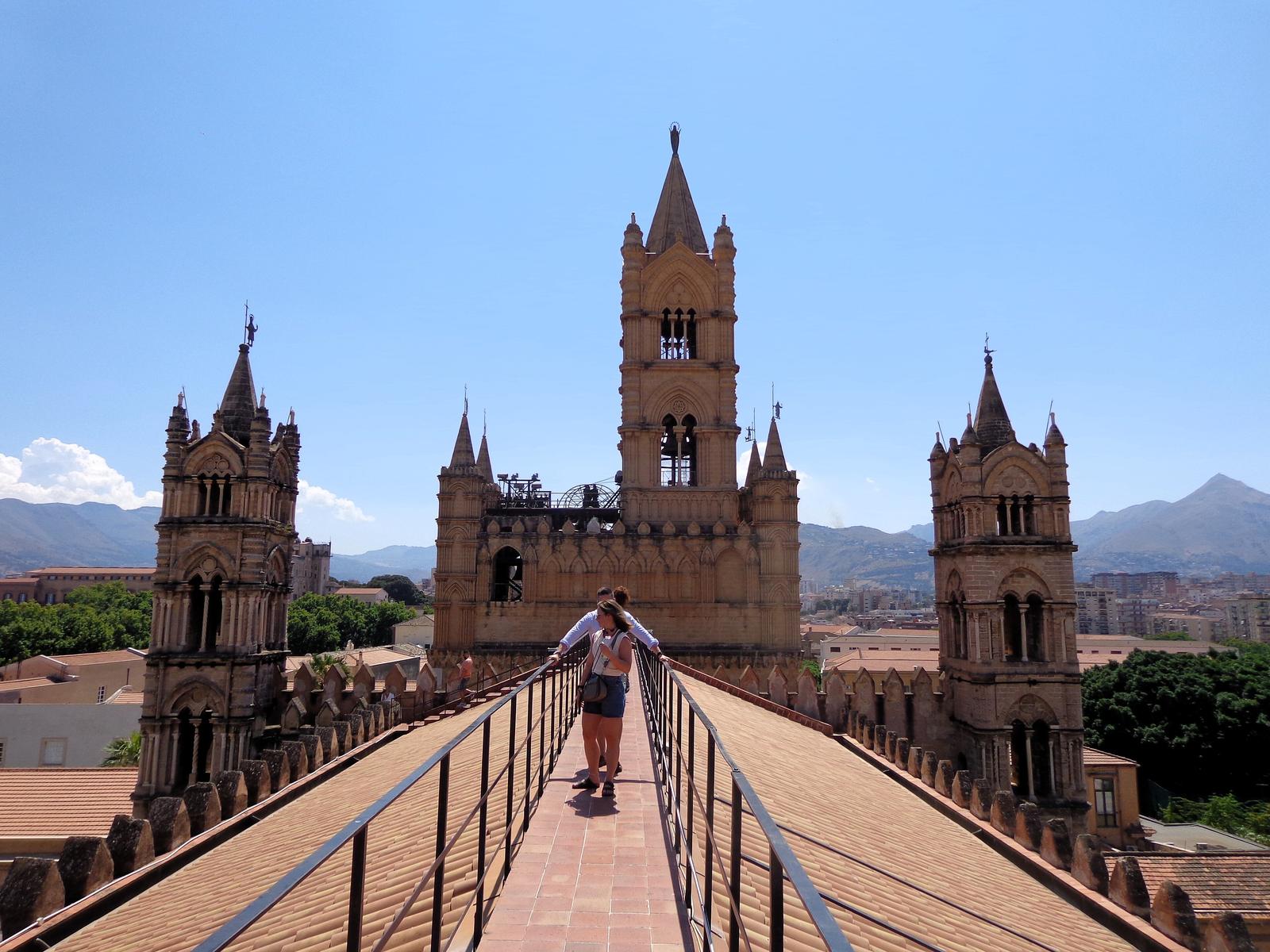 The rooftop and Arab-Norman towers of Palermo Cathedral against a blue sky