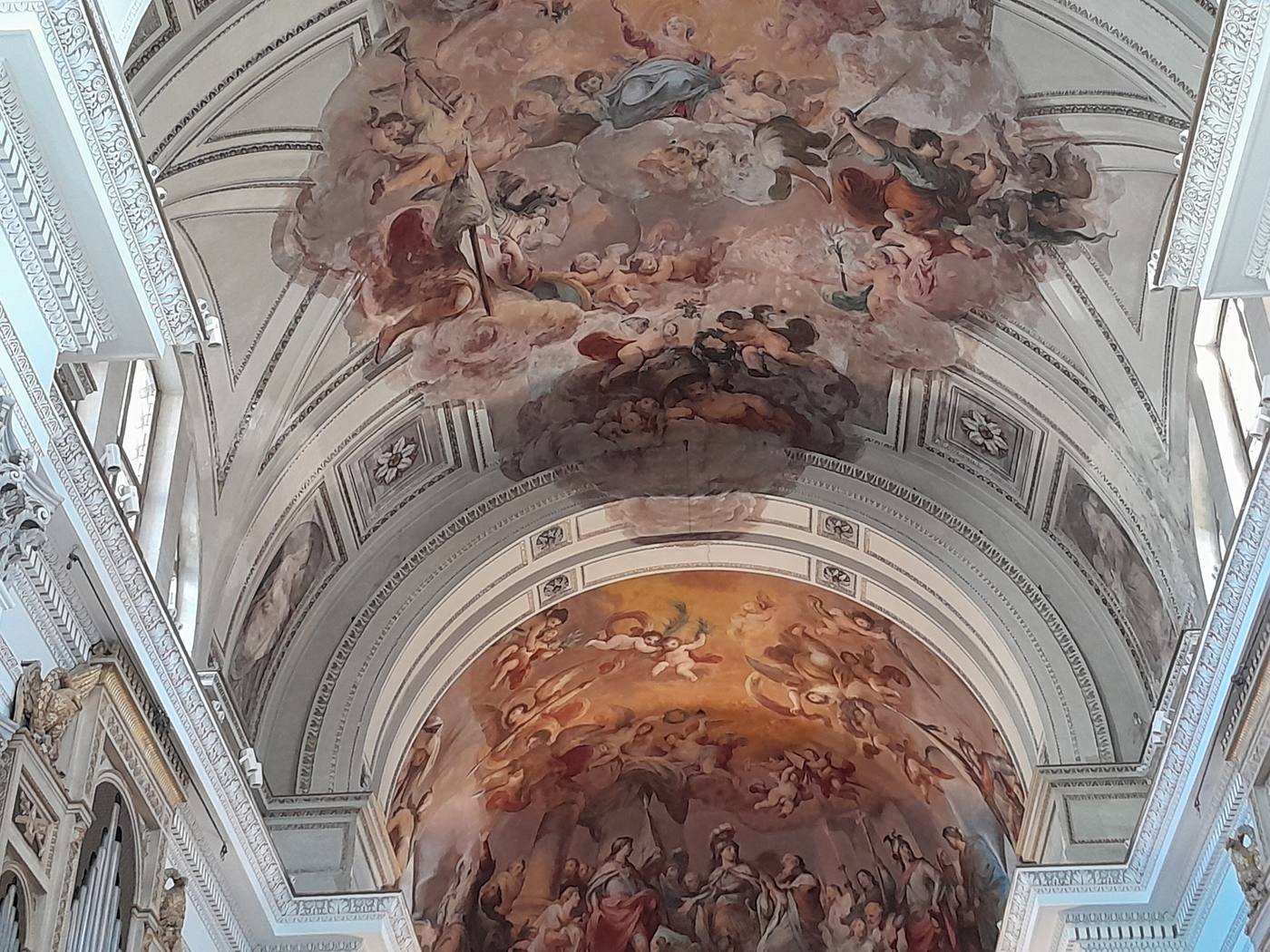 The ornate Baroque interior of a Palermo church, with frescoes and gilded decoration
