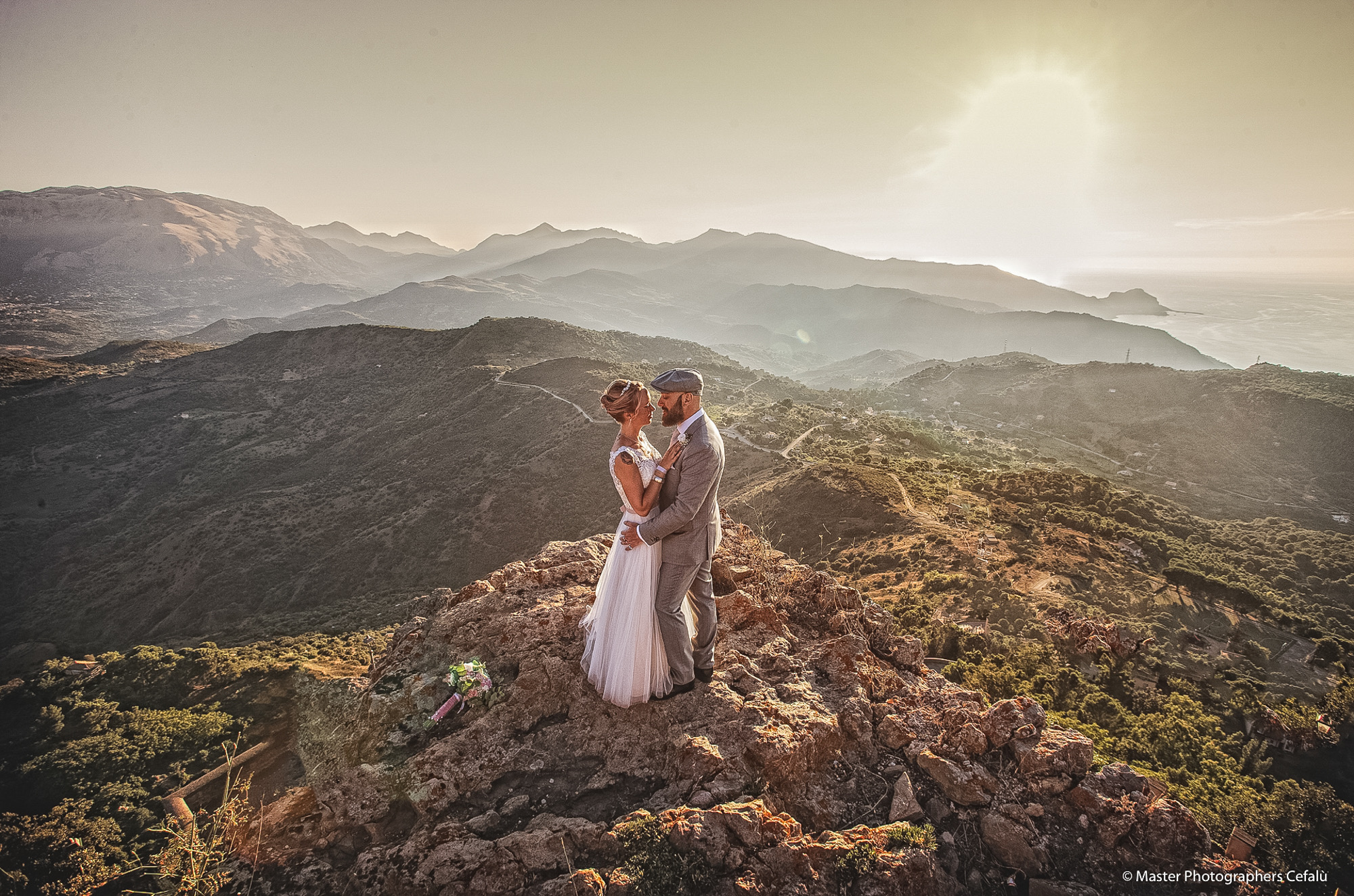 Couple at a mountain viewpoint over the Sicilian coast
