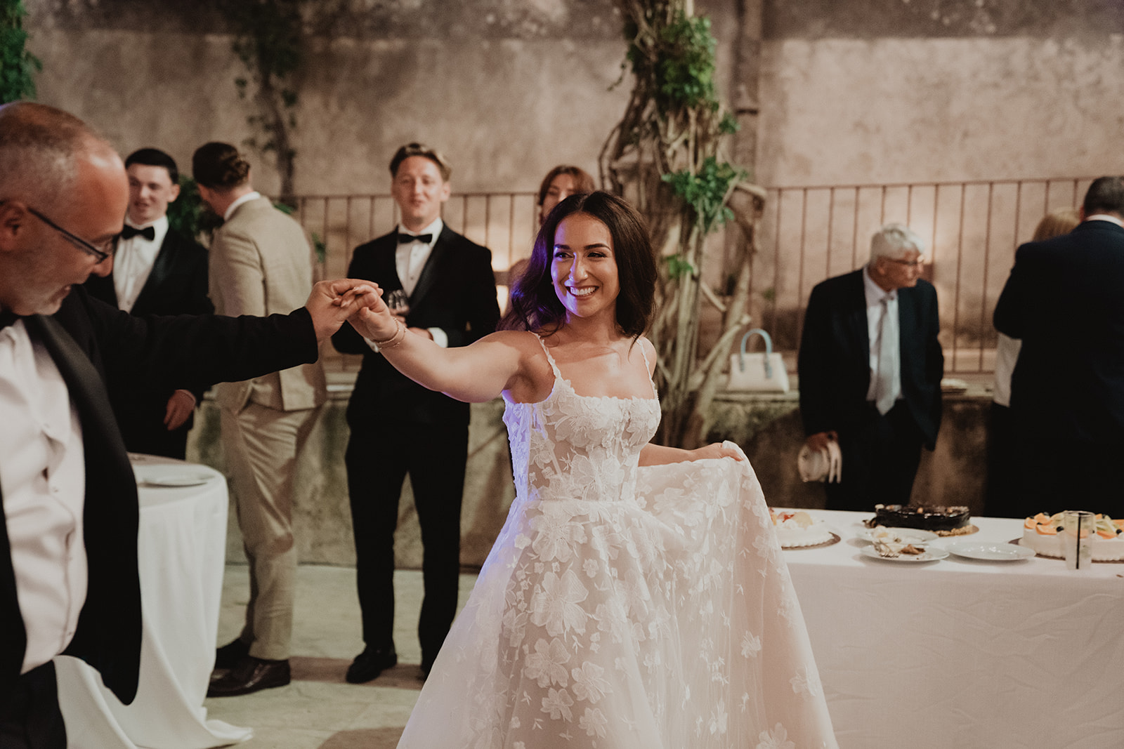 Lidia smiling as she dances with her father