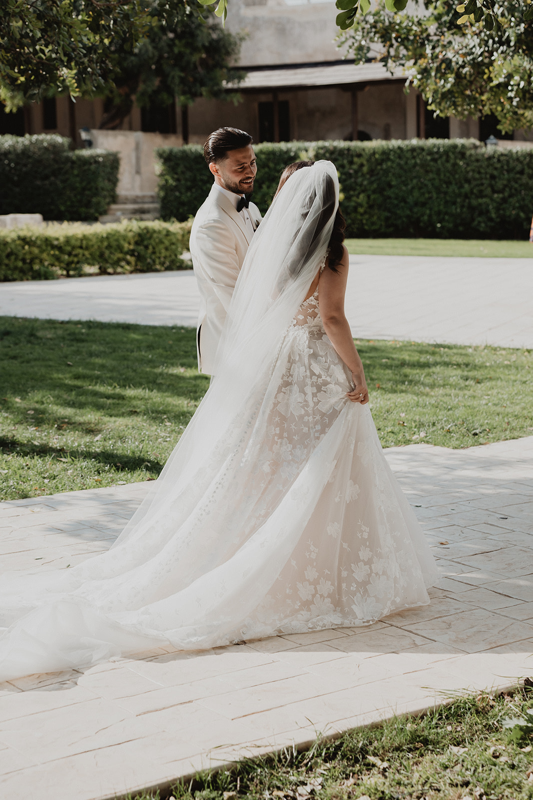 Lidia and Rian together, the back and train of Lidia’s wedding dress on show