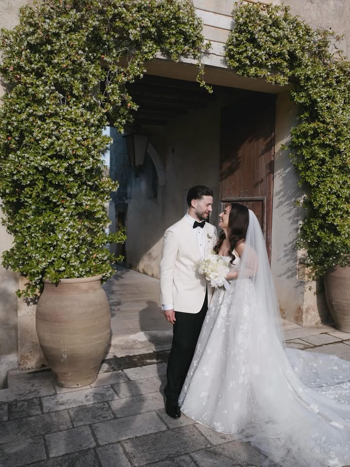 Lidia and Rian beneath a stone arch at Borgo del Carato