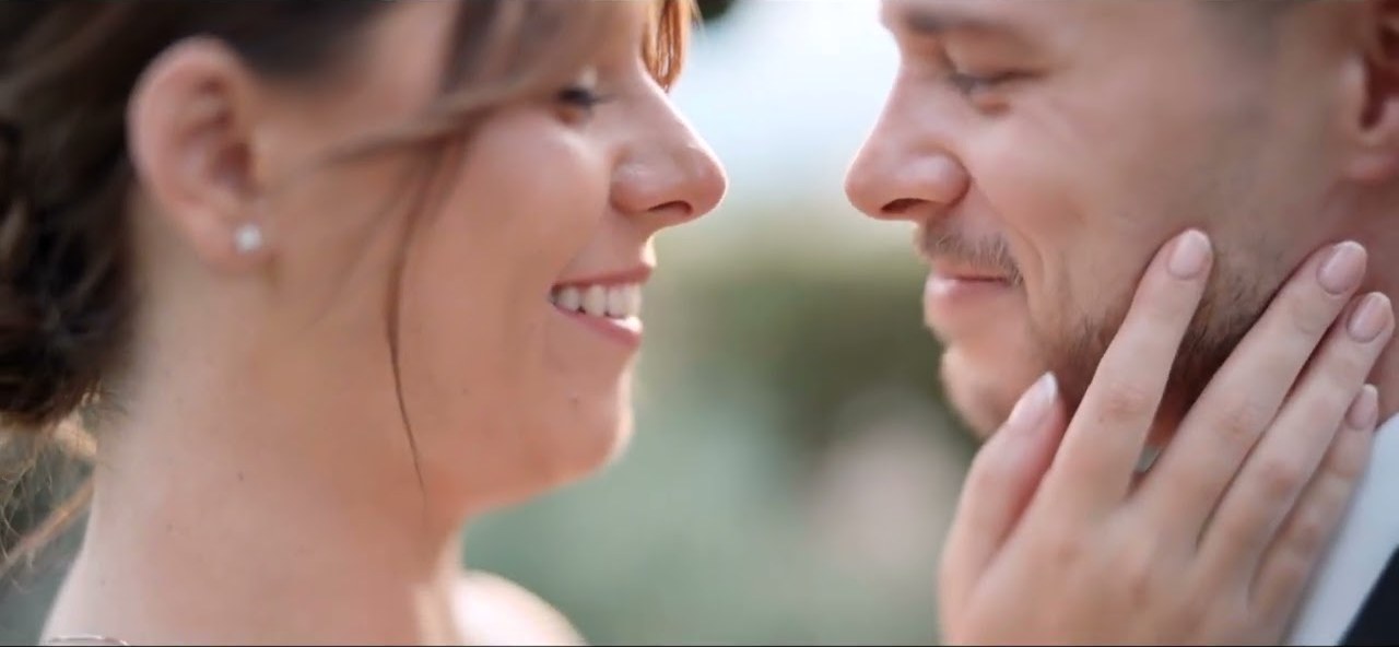 Tia and Tom smiling nose to nose on their wedding day in Taormina, a still from their wedding film