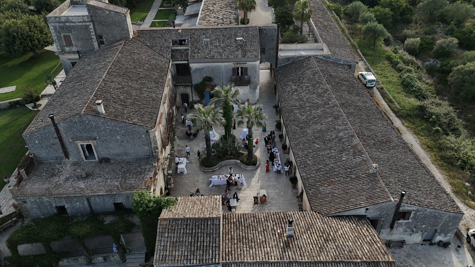 Aerial view of the stone buildings and courtyards of Borgo del Carato, an exclusive-use country estate wedding venue near Siracusa