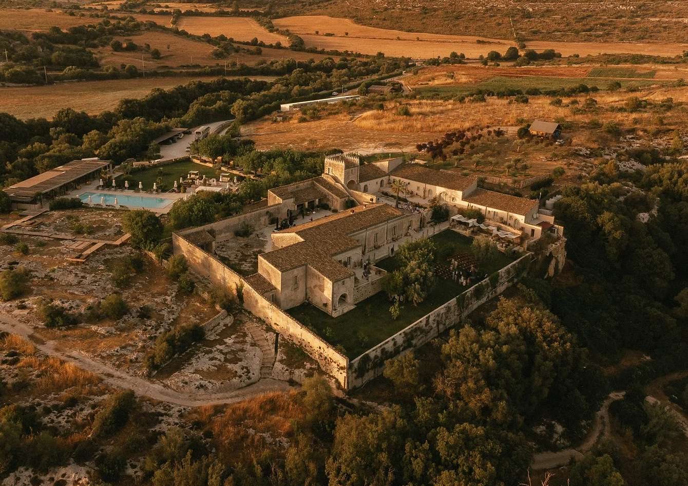 Aerial view of Dimora delle Balze, a 19th-century estate wedding venue in the Val di Noto countryside near Noto, Sicily, at golden hour